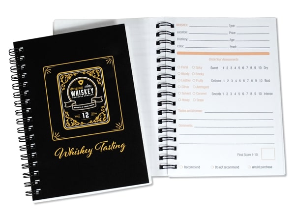 A whiskey tasting notebook featuring elegant design, perfect for recording notes and experiences in a business setting.